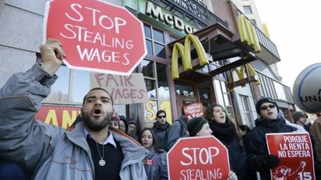 Zev Nicholson, of Boston, left, chants during a