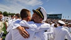 Midshipman Dustin Myers of Merritt Island, Florida, hugs
