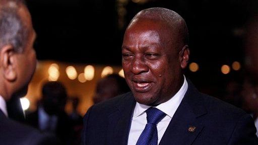 Ghanian President John Dramani Mahama, right, speaks to