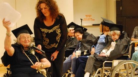 Valedictorian Berthe Gersten, 93, of Commack, congratulates fellow