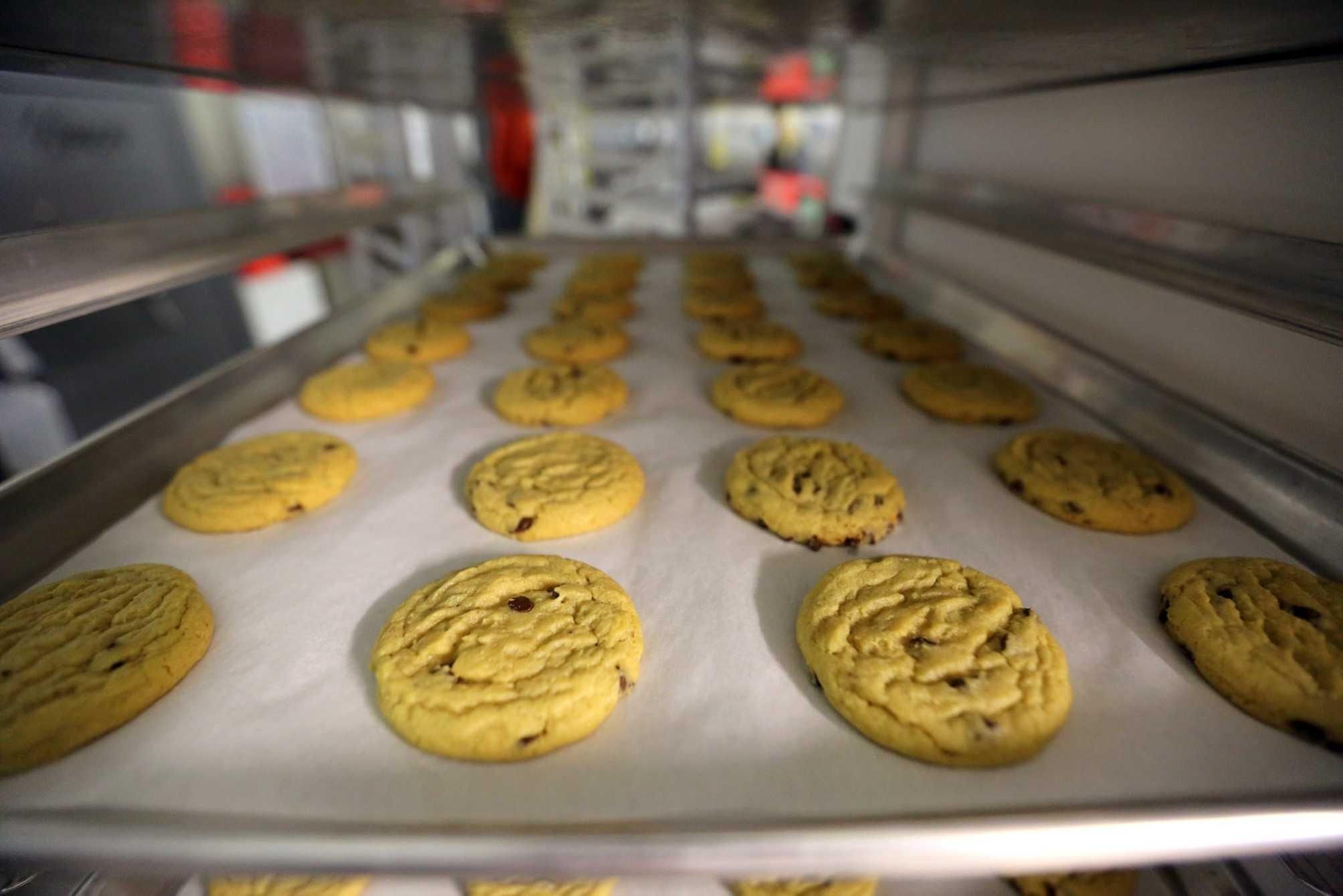 Freshly baked cannabis-infused cookies cool on a rack inside Sweet Grass Kitchen in Denver, a gourmet marijuana edibles bakery that sells  to retail outlets in Colorado. Credit: AP / Brennan Linsley
