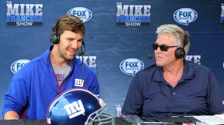 Giants quarterback Eli Manning, left, is interviewed by