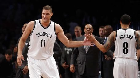 Nets' Brook Lopez celebrates with teammate Brooklyn Nets'
