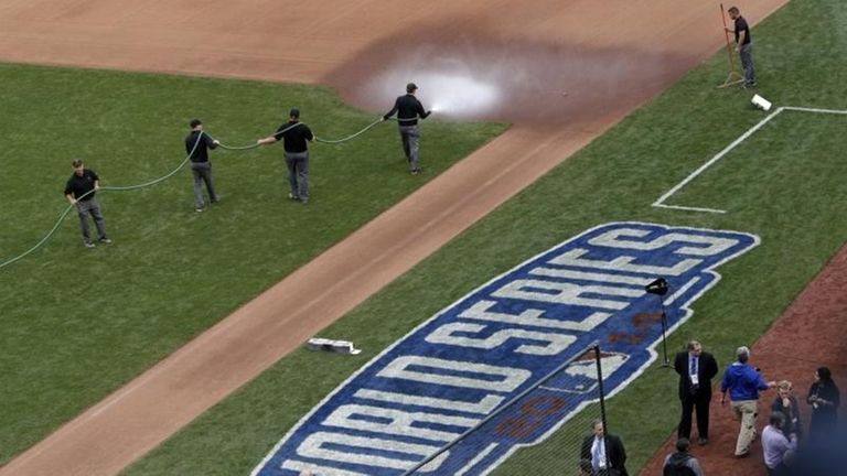 The grounds crew waters down the area near