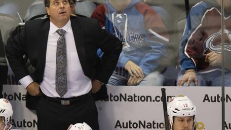 Islanders head coach Jack Capuano, back, reacts after