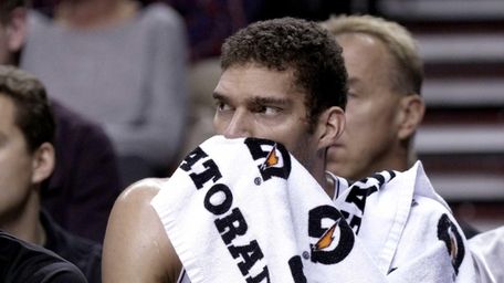 Brooklyn Nets center Brook Lopez watches from the