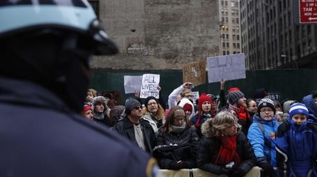 NYPD officers form a barrier between demonstrators at
