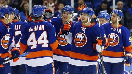 The New York Islanders celebrate after defeating the