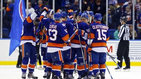 The New York Islanders celebrate after defeating the