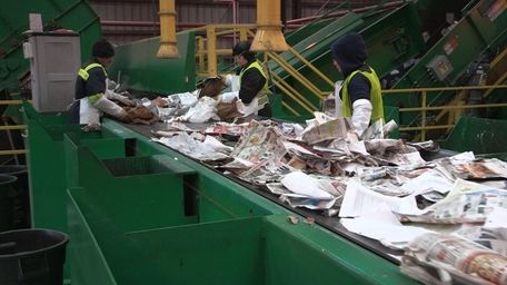 Employees sort paper at the Green Stream recycling